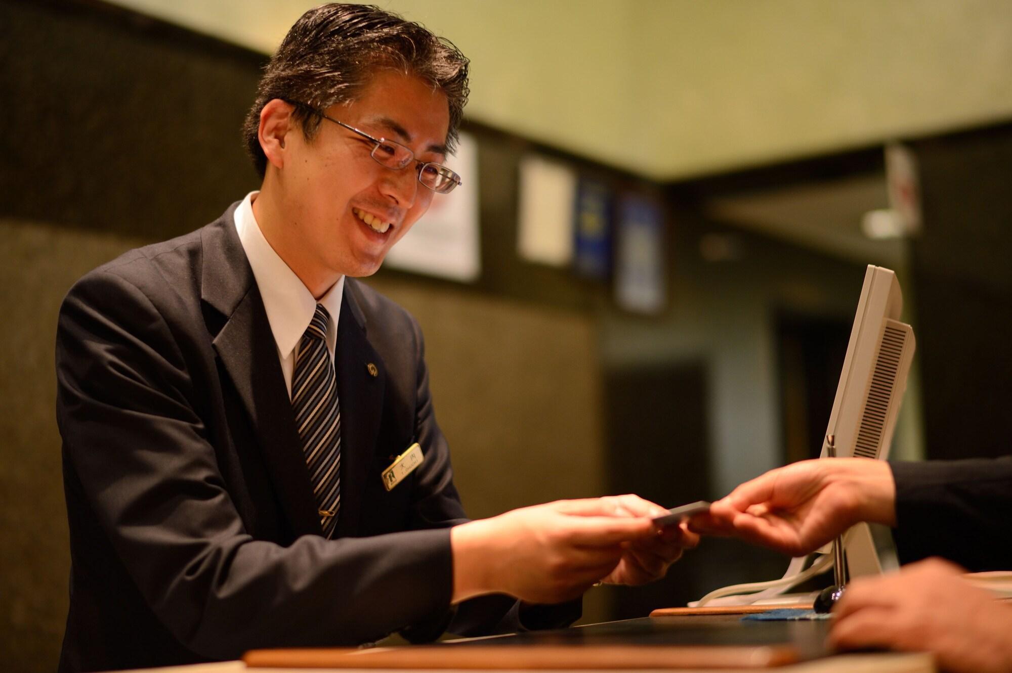 Royton Sapporo Hotel Kültér fotó A hotel clerk at the front desk