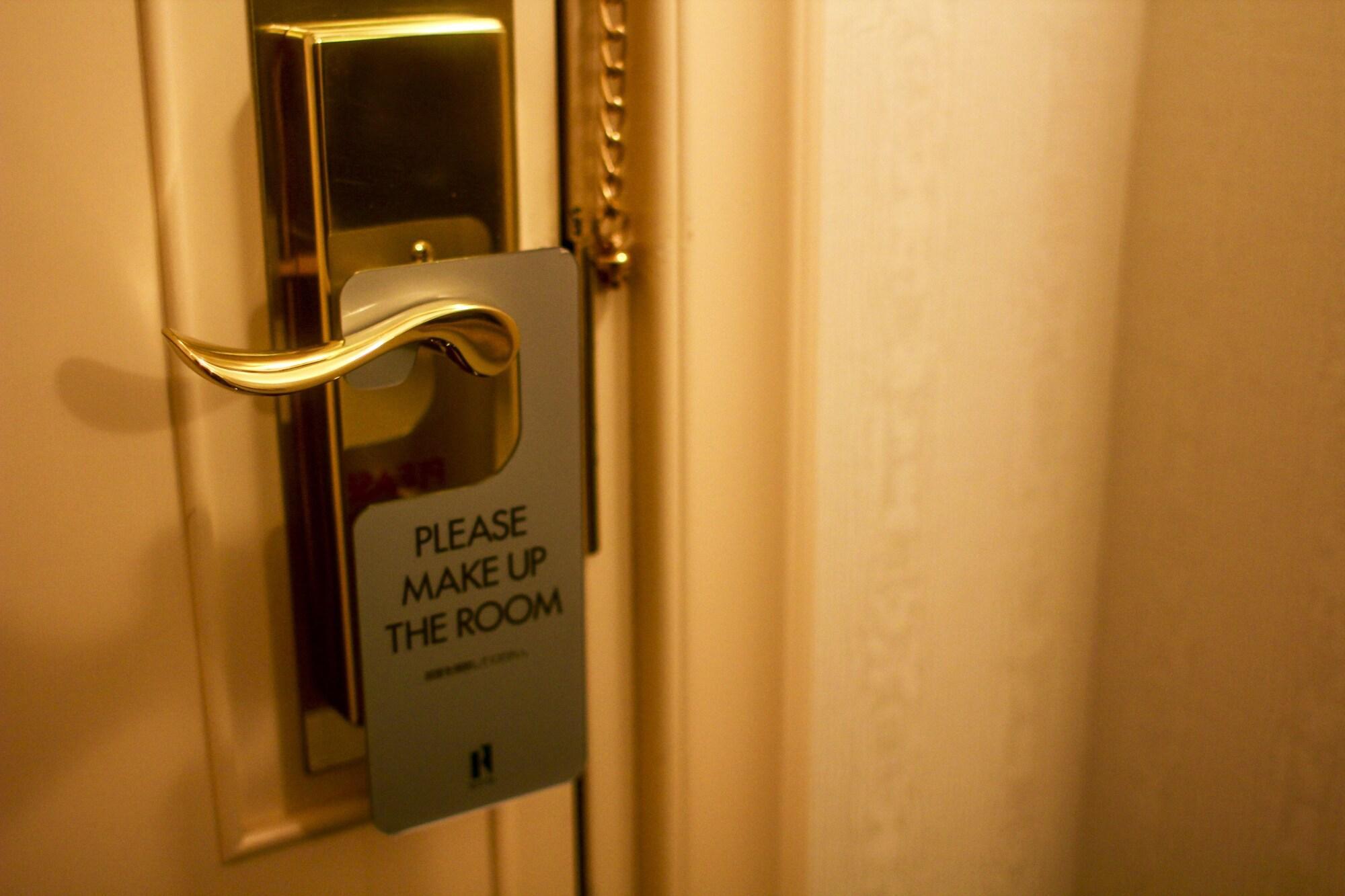 Royton Sapporo Hotel Kültér fotó A door sign requesting a maid service